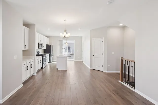 a view of a kitchen with wooden floor and a window