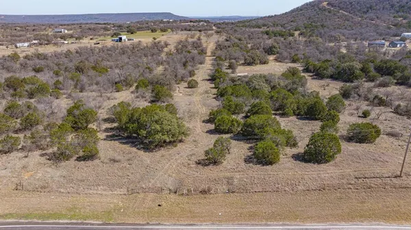 an aerial view of mountain with trees in the background