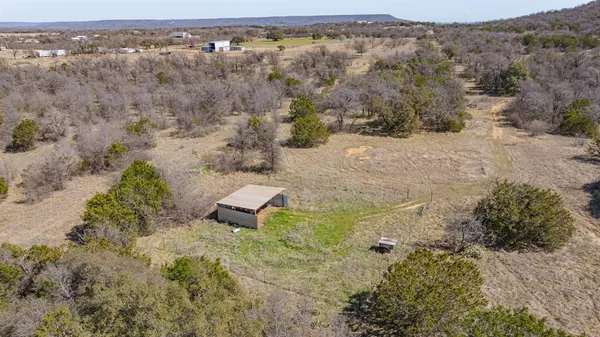 an aerial view of mountain with yard