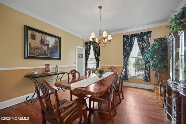 a kitchen with a table chairs refrigerator and microwave