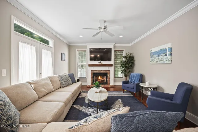 a living room with furniture kitchen view and a potted plant