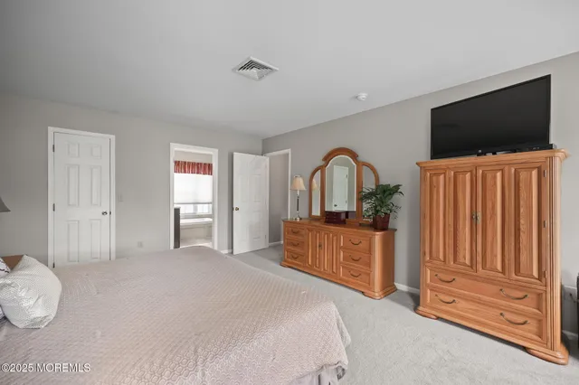 a bedroom with two beds and a flat screen tv