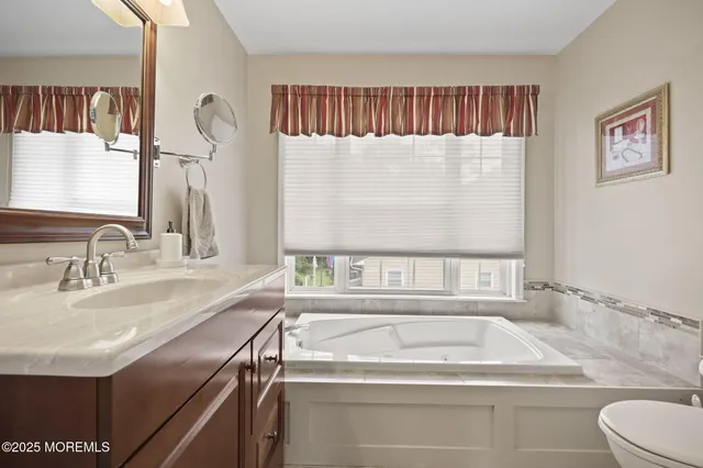 a bathroom with a toilet a sink and a mirror