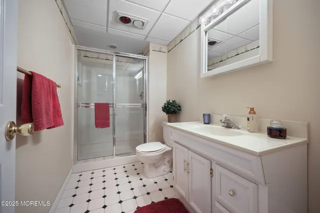 a view of a roof deck with table and chairs under an umbrella with wooden floor