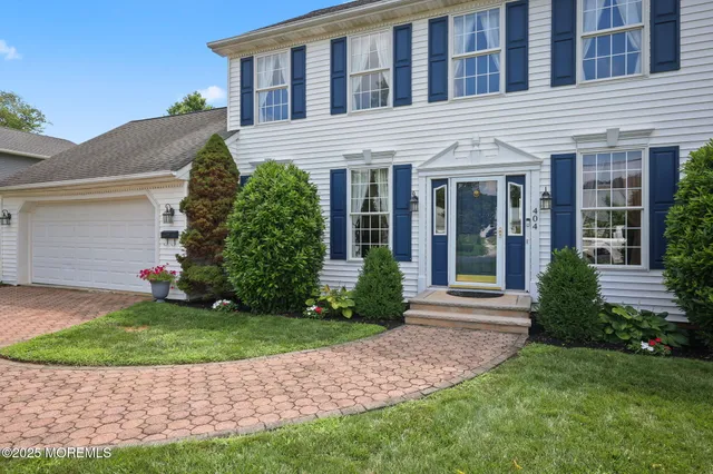 a front view of a house with a garden and yard