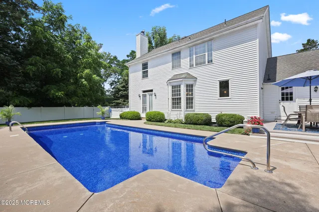 an aerial view of a house with swimming pool outdoor seating and yard