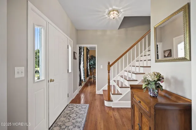 a view of entryway with wooden floor and stairs
