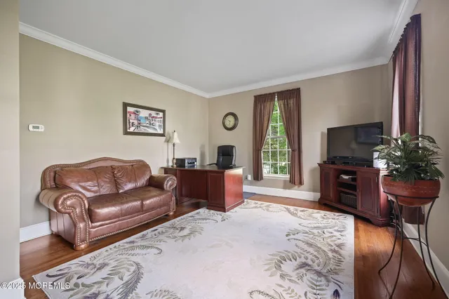 a bedroom with a bed and large windows