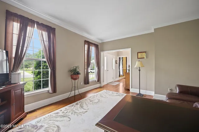 a view of a dining room with furniture window and wooden floor