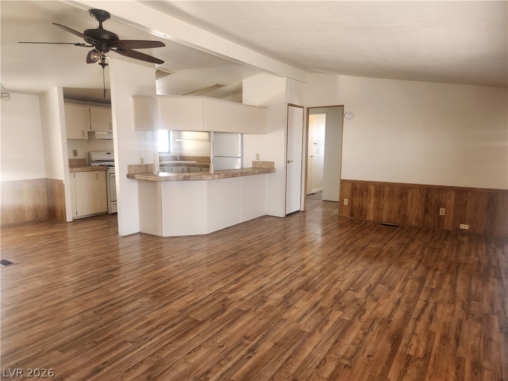 3189 Del Monte Street Laughlin, NV 89029 - Photo 5 of 32 An open-concept living area with lustrous wood flooring flows into a well-appointed kitchen.