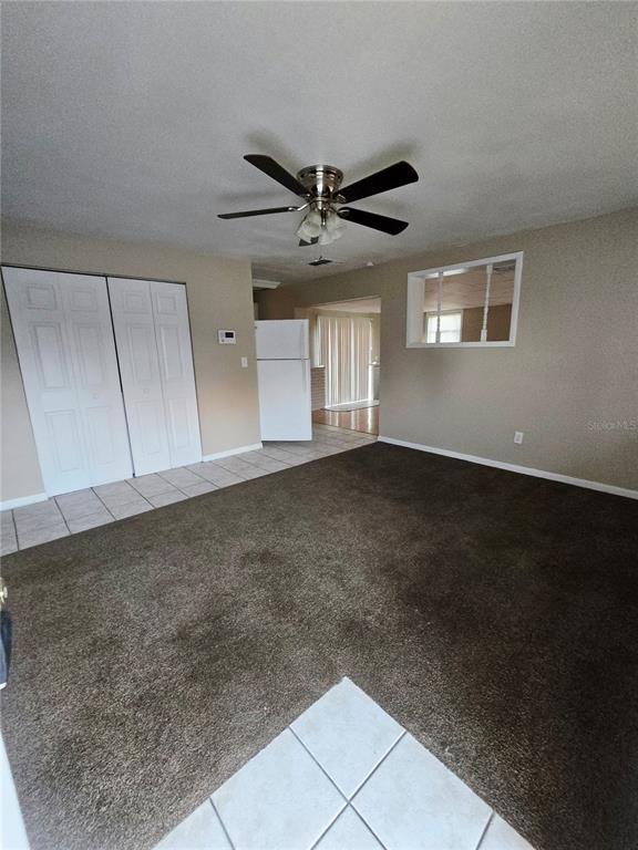4370 Osage Lane Spring Hill, FL 34608 - Photo 2 of 11 a view of an empty room with a ceiling fan and window