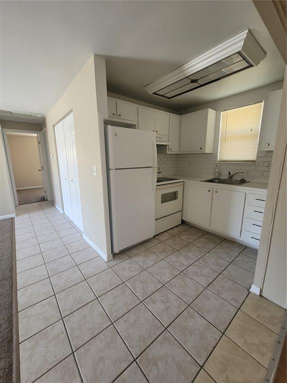 4370 Osage Lane Spring Hill, FL 34608 - Photo 3 of 11 a kitchen with a cabinets and white appliances