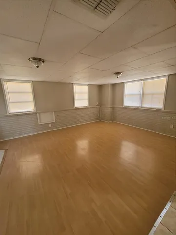 an empty room with a empty space and windows