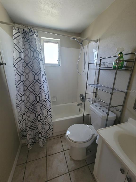 4370 Osage Lane Spring Hill, FL 34608 - Photo 10 of 11 a white toilet sitting next to a shower curtain