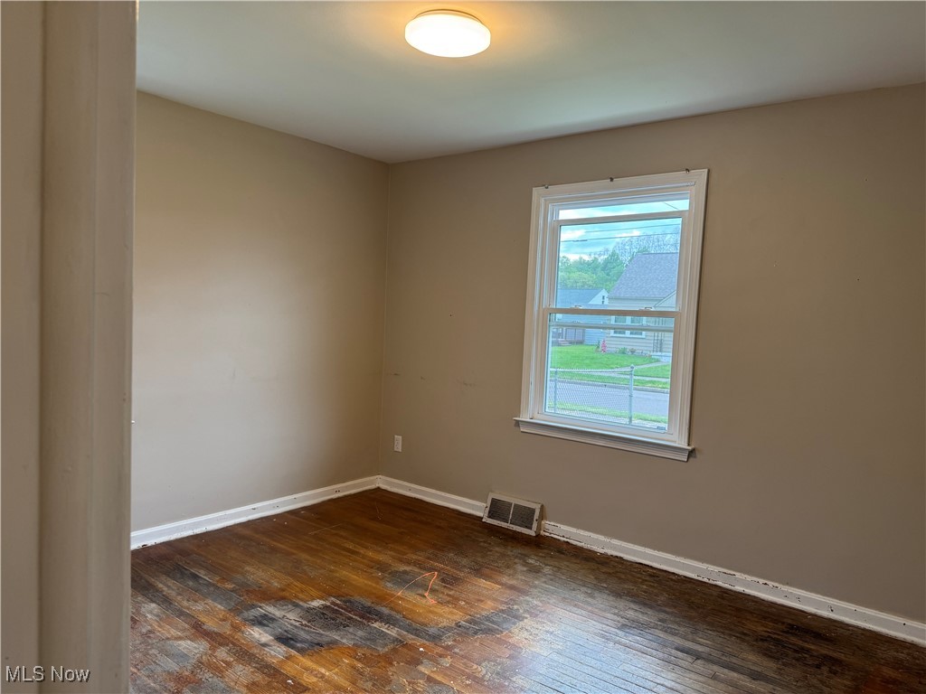 1139 Kessel Avenue Akron, OH 44310 - Photo 27 of 36 Spare room with dark wood-type flooring and baseboards