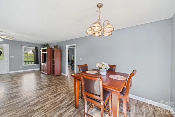 a view of a dining room with furniture wooden floor and chandelier