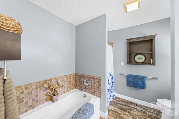 a bathroom with a bathtub and a shower