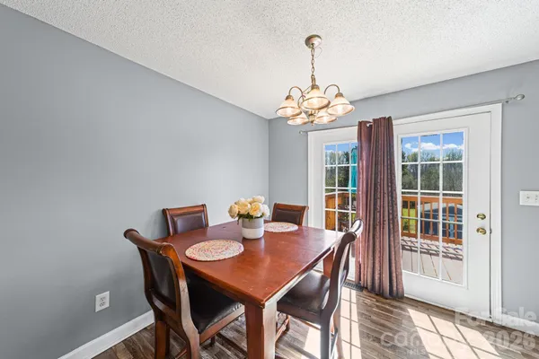 a view of a dining room with a table and chairs