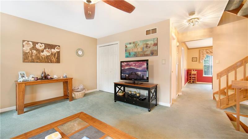 140 Terra Drive McKees Rocks, PA 15136 - Photo 7 of 25 Living room with view into the dining room. Door to the left of the steps is the powder room