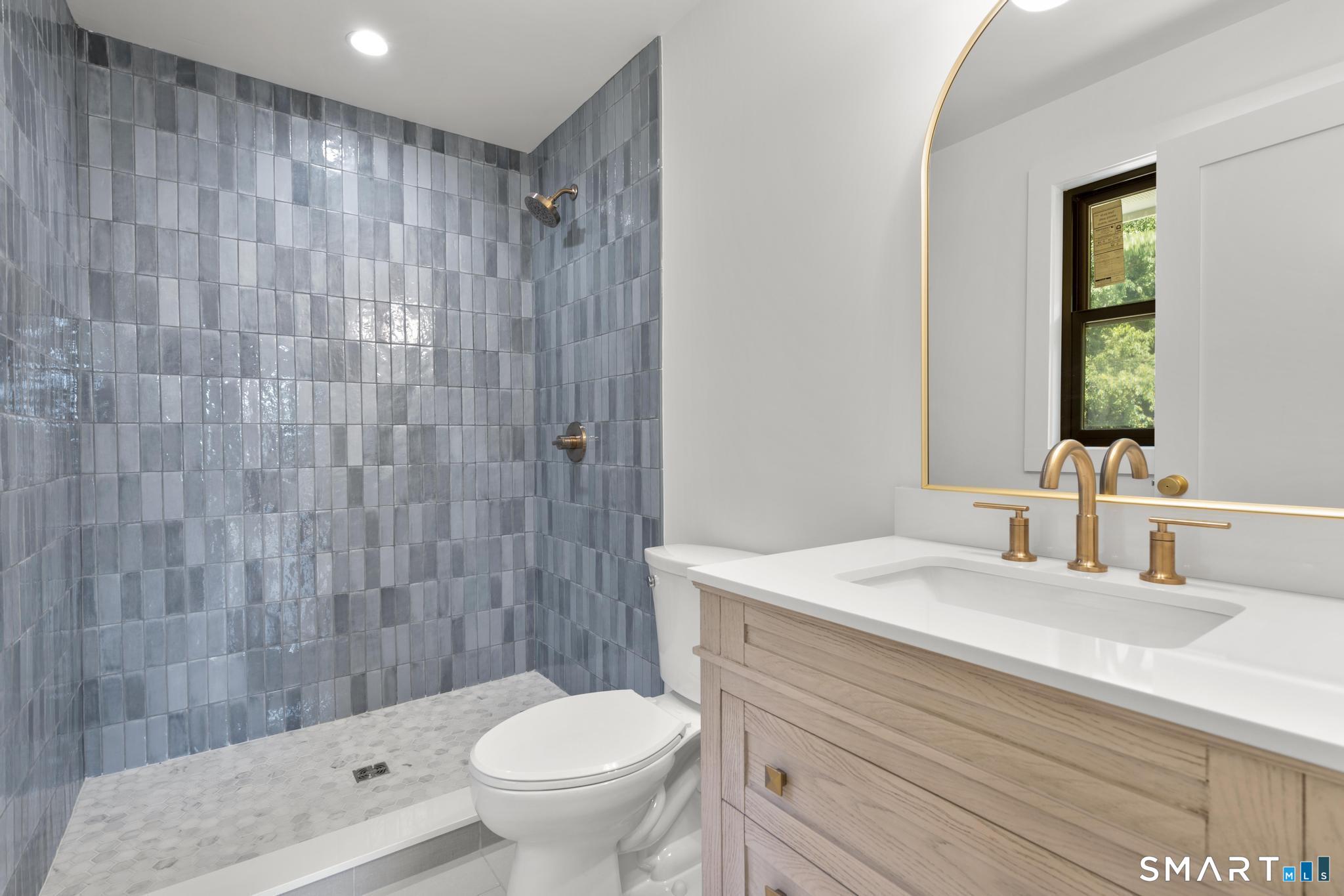 22 Beaver Brook Road Ridgefield, CT 06877 - Photo 24 of 40 a bathroom with a sink a toilet and shower