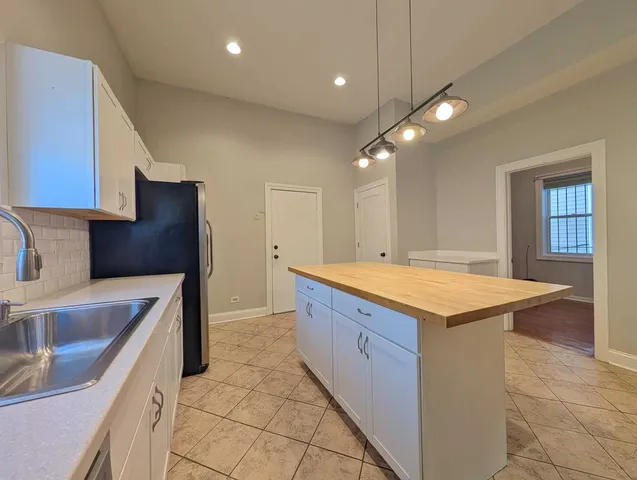 a kitchen with granite countertop a sink and a stove