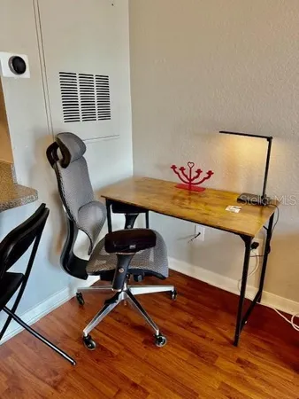 a bathroom with a toilet and a chair