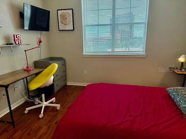 a bedroom with furniture and a wooden floor