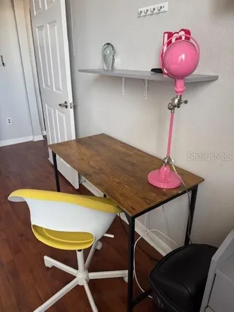 a bedroom with furniture and a wooden floor