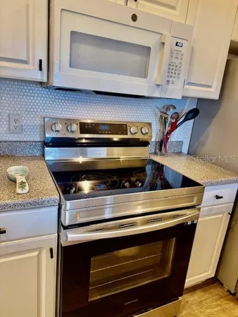 a stove top oven sitting inside of a kitchen