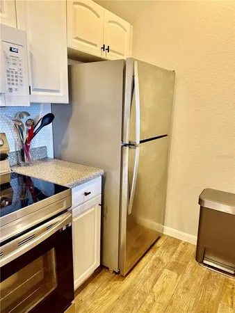a kitchen with stainless steel appliances granite countertop a sink dishwasher stove and refrigerator