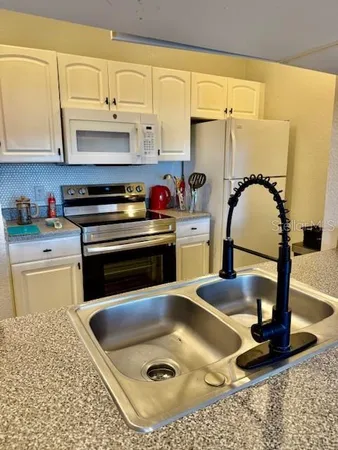 a bathroom with a sink vanity mirror and tub