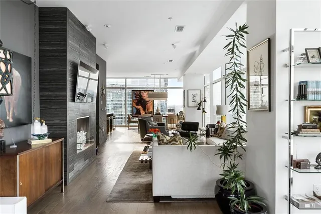 a living room with furniture and floor to ceiling windows
