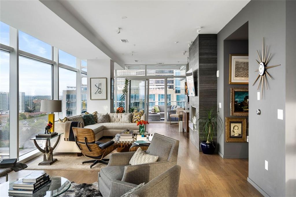 45 Ivan Allen Jr Boulevard Northwest, Unit 1702 Atlanta, GA 30308 - Photo 16 of 94 a living room with furniture and floor to ceiling windows