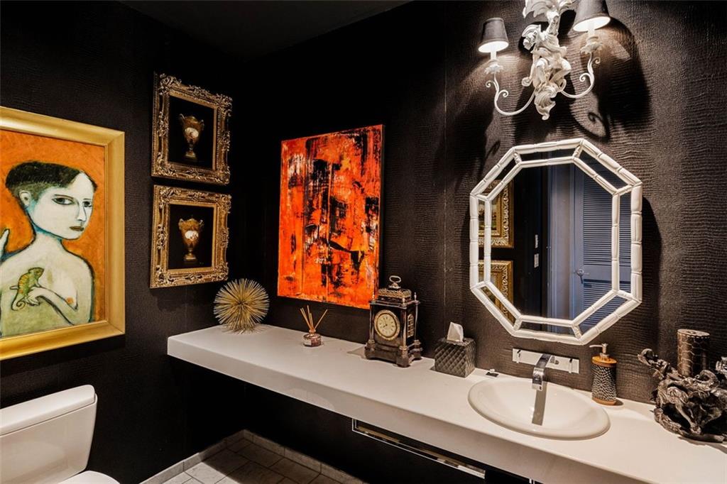 45 Ivan Allen Jr Boulevard Northwest, Unit 1702 Atlanta, GA 30308 - Photo 18 of 94 a bathroom with a sink a toilet and a mirror