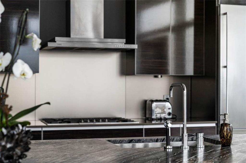 45 Ivan Allen Jr Boulevard Northwest, Unit 1702 Atlanta, GA 30308 - Photo 22 of 94 a kitchen with granite countertop a stove and a microwave