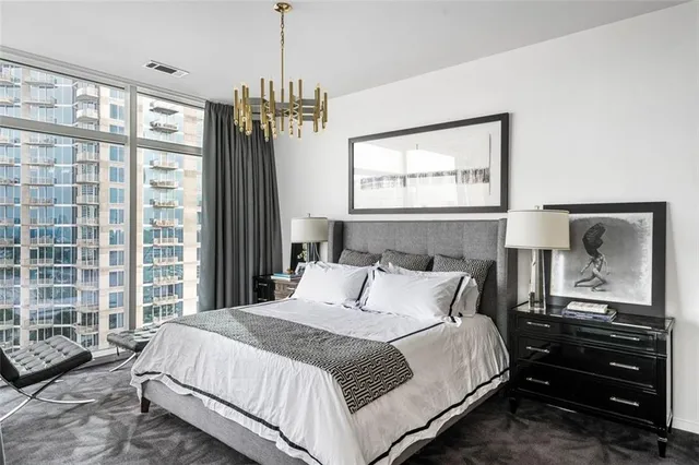 a living room filled with furniture and a floor to ceiling window