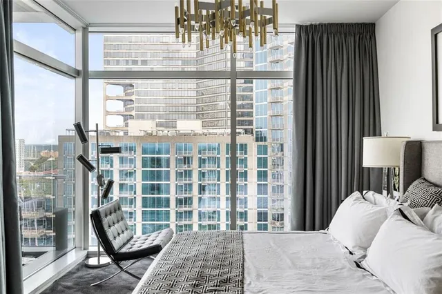 a living room with furniture and a floor to ceiling window
