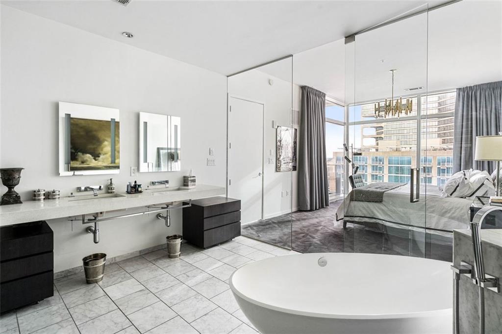 45 Ivan Allen Jr Boulevard Northwest, Unit 1702 Atlanta, GA 30308 - Photo 39 of 94 a large white kitchen with a large window and stainless steel appliances