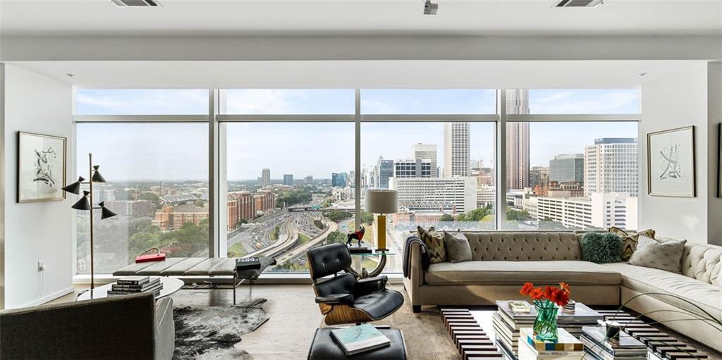 45 Ivan Allen Jr Boulevard Northwest, Unit 1702 Atlanta, GA 30308 - Photo 4 of 94 a living room with furniture and a floor to ceiling window