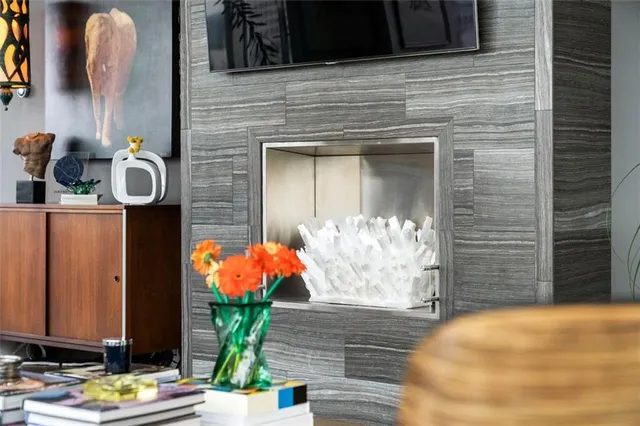 a living room with fireplace furniture and a large window