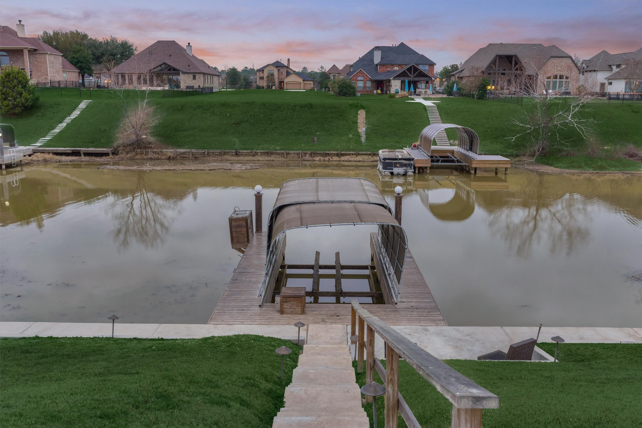 11618 Renaissance Drive Montgomery, TX 77356 - Photo 42 of 49 A concrete sidewalk and stairs lead to the boat dock that has been recently dredged for deeper water. Additional concrete decking at the bulkhead offers additional space for seating and fishing by the water.