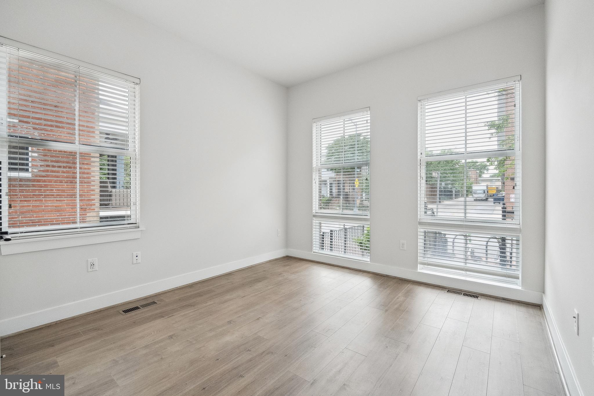 1339 E Street Southeast, Unit 9 Washington, DC 20003 - Photo 16 of 35 a view of an empty room with wooden floor and a window