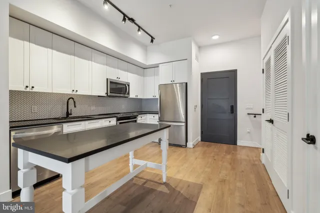 a view of a livingroom with furniture wooden floor and windows