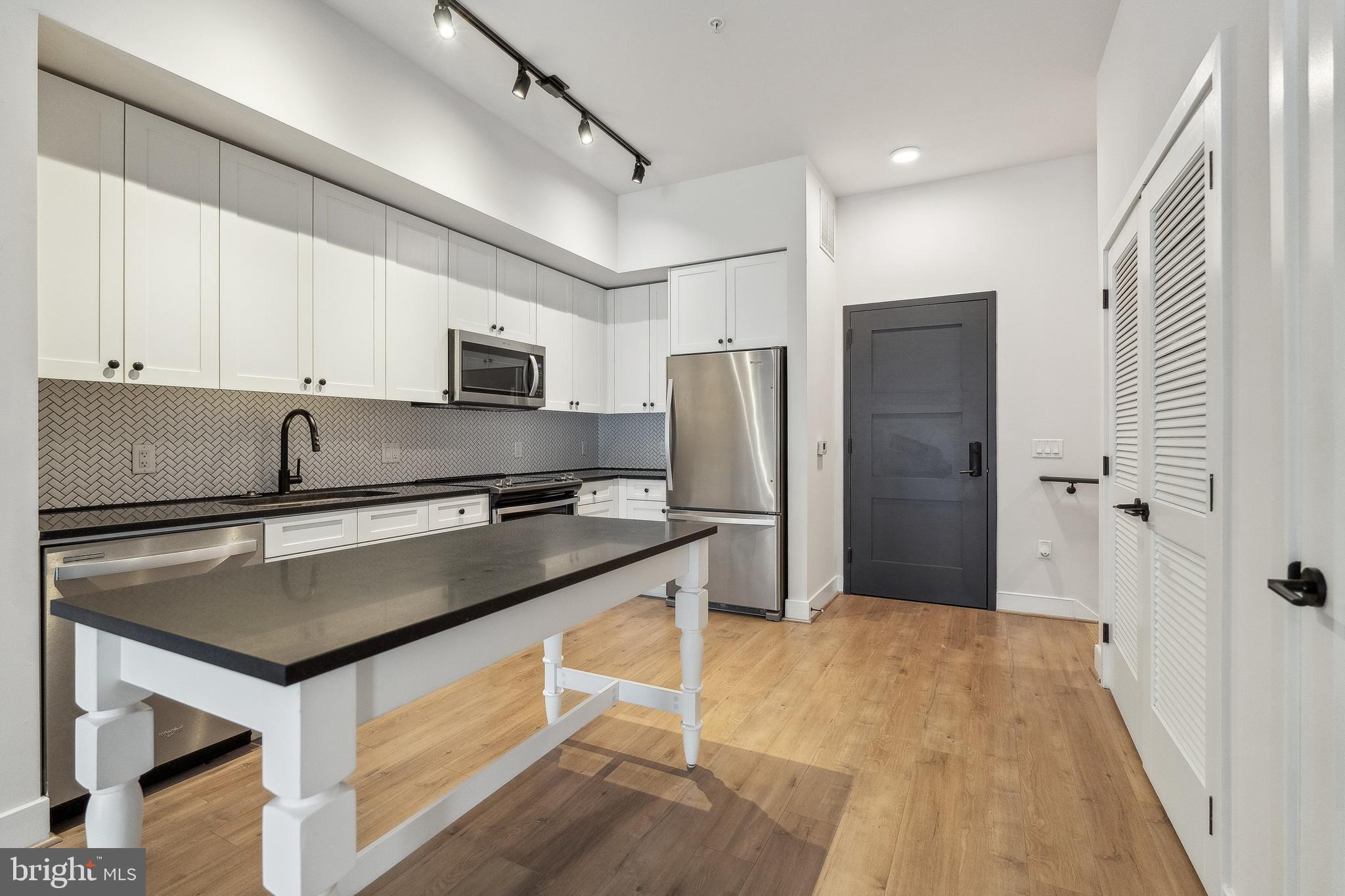 1339 E Street Southeast, Unit 9 Washington, DC 20003 - Photo 10 of 35 a kitchen with stainless steel appliances granite countertop a sink stove and refrigerator