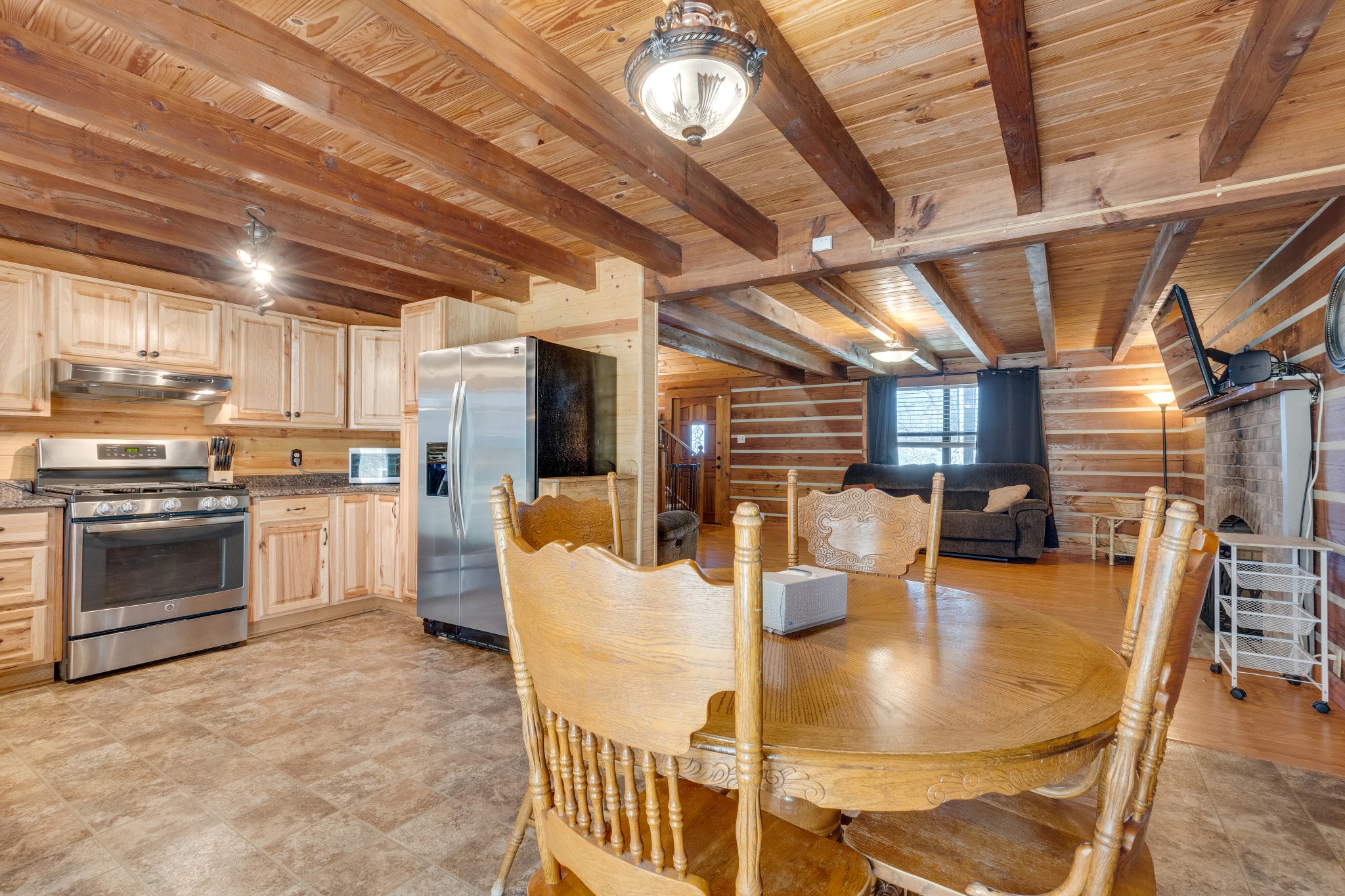 324 Shorts Road Pulaski, TN 38478 - Photo 14 of 40 a kitchen with stainless steel appliances granite countertop a stove a refrigerator a dining table and chairs with wooden floor