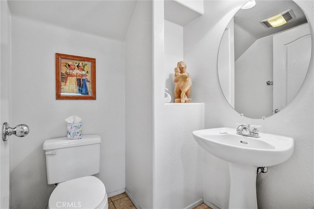 65 Windward Way Buena Park, CA 90621 - Photo 11 of 50 a bathroom with a toilet sink and mirror