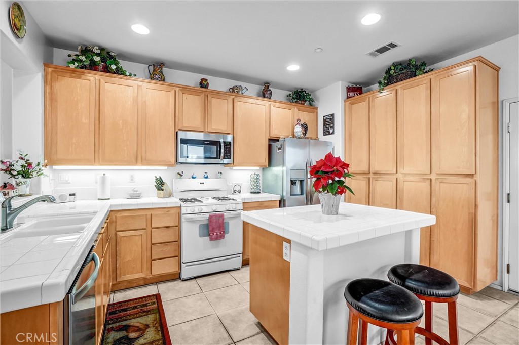 65 Windward Way Buena Park, CA 90621 - Photo 16 of 50 a kitchen with a sink stove and refrigerator