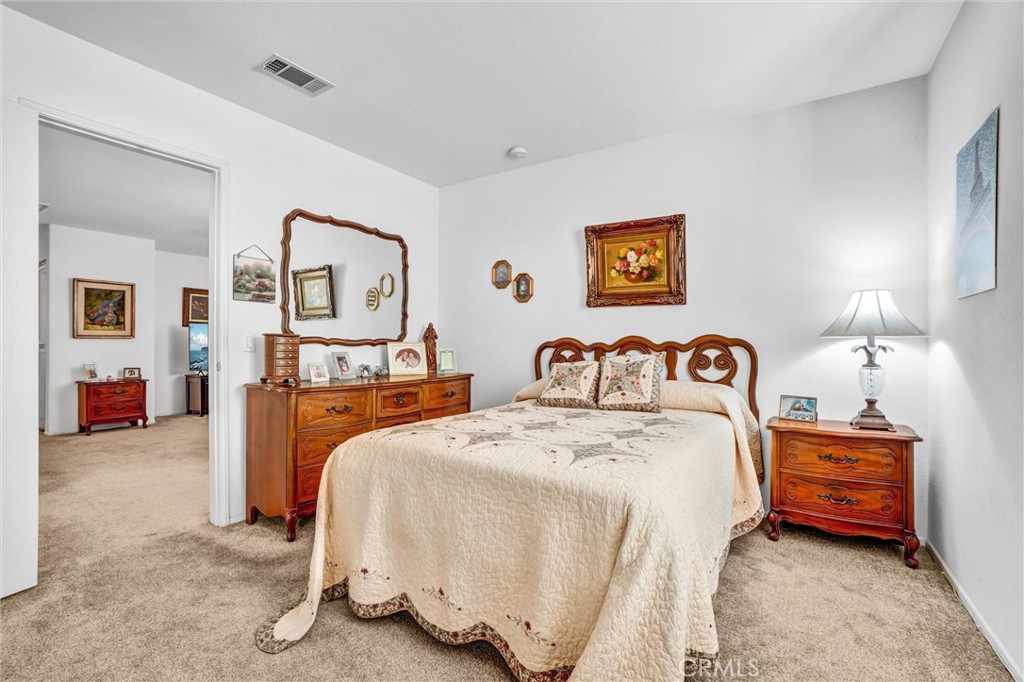 65 Windward Way Buena Park, CA 90621 - Photo 30 of 50 a bedroom with bed and window