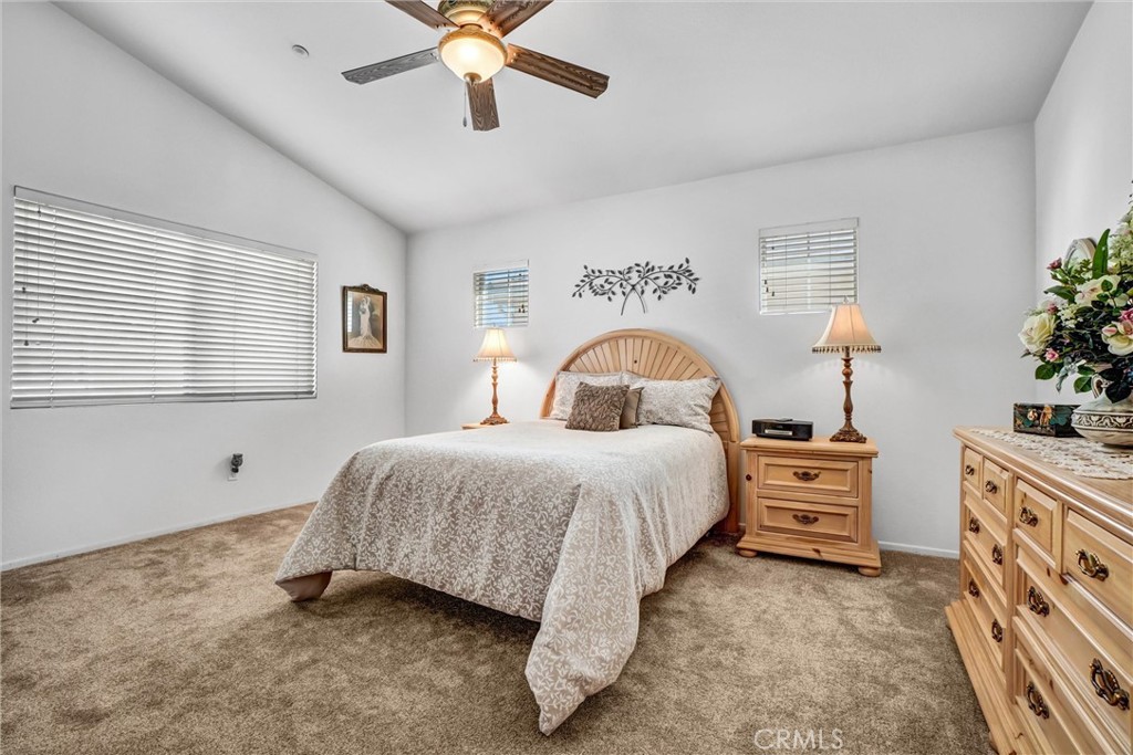 65 Windward Way Buena Park, CA 90621 - Photo 35 of 50 a bedroom with a bed and a chandelier