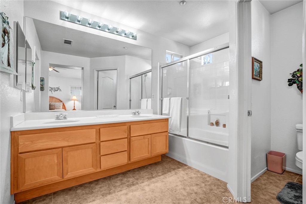 65 Windward Way Buena Park, CA 90621 - Photo 38 of 50 a bathroom with a double vanity sink a mirror and a shower